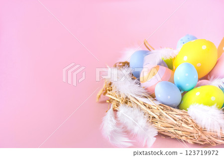 Nest with Easter eggs on a pink background with a copy space 123719972