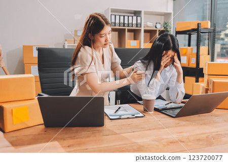 Startup SME small business entrepreneur of freelance Asian woman using a laptop with box Cheerful success Asian woman her hand lifts up online marketing packaging box and delivery SME idea concept 123720077