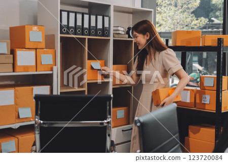 Asian SME business women use laptop computer checking customer order online shipping boxes at home. Starting Small business entrepreneur SME freelance. Online business, Work at home concept. 123720084