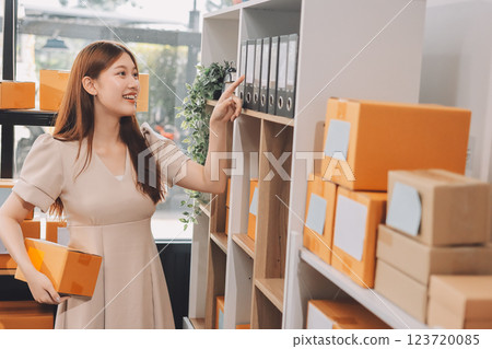 Asian SME business women use laptop computer checking customer order online shipping boxes at home. Starting Small business entrepreneur SME freelance. Online business, Work at home concept. 123720085