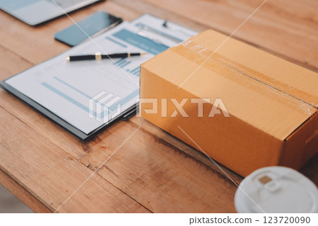 Asian SME business women use laptop computer checking customer order online shipping boxes at home. Starting Small business entrepreneur SME freelance. Online business, Work at home concept. 123720090