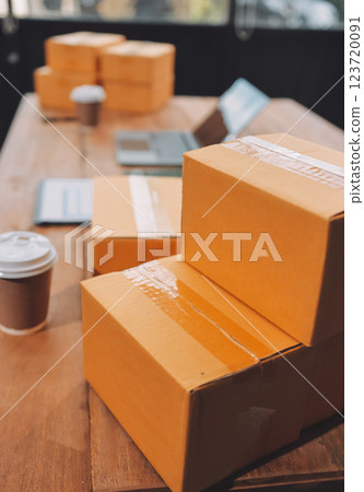 Asian SME business women use laptop computer checking customer order online shipping boxes at home. Starting Small business entrepreneur SME freelance. Online business, Work at home concept. Asian SME business women use laptop computer checking customer order online shipping boxes at home. Starting Small business entrepreneur SME freelance. Online business, Work at home concept. 123720091