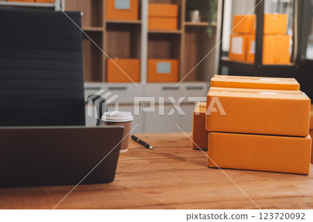 Asian SME business women use laptop computer checking customer order online shipping boxes at home. Starting Small business entrepreneur SME freelance. Online business, Work at home concept. 123720092