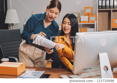 Asian SME business women use laptop computer checking customer order online shipping boxes at home. Starting Small business entrepreneur SME freelance. Online business, Work at home concept. 123720096