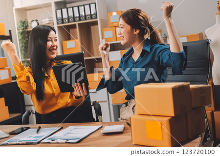 Asian SME business women use laptop computer checking customer order online shipping boxes at home. Starting Small business entrepreneur SME freelance. Online business, Work at home concept. 123720100