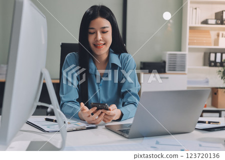 Entrepreneur Asian businessman and businesswoman discussing new business project in tablet in modern Meeting In Modern Office, Asian business casual concept. 123720136