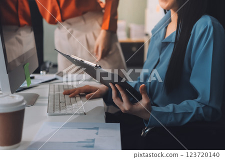Entrepreneur Asian businessman and businesswoman discussing new business project in tablet in modern Meeting In Modern Office, Asian business casual concept. 123720140