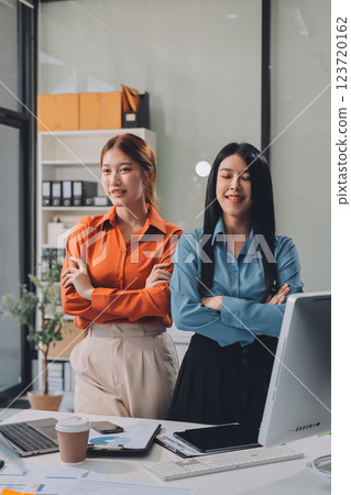 Portrait happy two young asian businesswoman standing with confident together in office, happiness two business woman arms crossed with success, coworker and friendship, business and team. 123720162