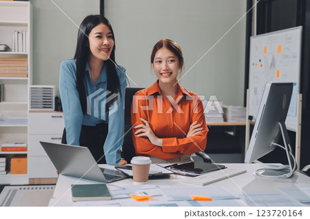 Portrait happy two young asian businesswoman standing with confident together in office, happiness two business woman arms crossed with success, coworker and friendship, business and team. 123720164