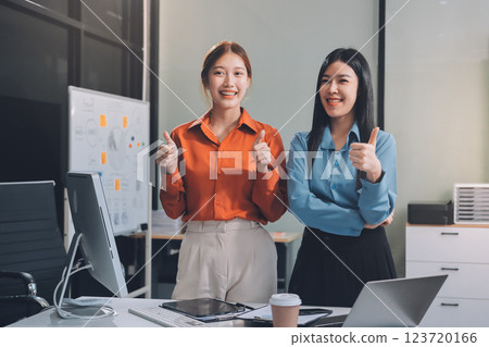 Portrait happy two young asian businesswoman standing with confident together in office, happiness two business woman arms crossed with success, coworker and friendship, business and team. Portrait happy two young asian businesswoman standing with confident together in office, happiness two business woman arms crossed with success, coworker and friendship, business and team. 123720166