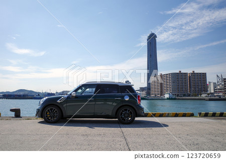 A photo of a car with the Straits Dream Tower in the background 123720659
