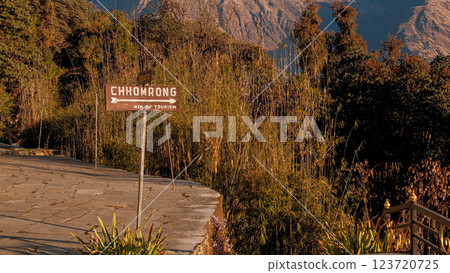 Sign to Chhomrong village, view from Tadapani with mountains in the morning light, wide shot 123720725