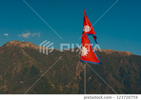 Nepal flag against green hills and blue sky with copy space Nepal flag against green hills and blue sky with copy space 123720759