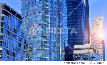 Glass building with transparent facade of the building and blue sky. Structural glass wall reflecting blue sky. Abstract modern architecture fragment. Contemporary architectural background. Glass building with transparent facade of the building and blue sky. Structural glass wall reflecting blue sky. Abstract modern architecture fragment. Contemporary architectural background. 123720874