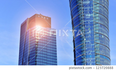 Glass building with transparent facade of the building and blue sky. Structural glass wall reflecting blue sky. Abstract modern architecture fragment. Contemporary architectural background. Glass building with transparent facade of the building and blue sky. Structural glass wall reflecting blue sky. Abstract modern architecture fragment. Contemporary architectural background. 123720888