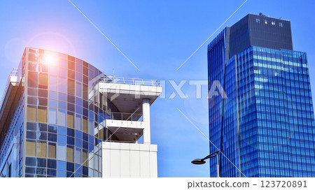 Glass building with transparent facade of the building and blue sky. Structural glass wall reflecting blue sky. Abstract modern architecture fragment. Contemporary architectural background. Glass building with transparent facade of the building and blue sky. Structural glass wall reflecting blue sky. Abstract modern architecture fragment. Contemporary architectural background. 123720891