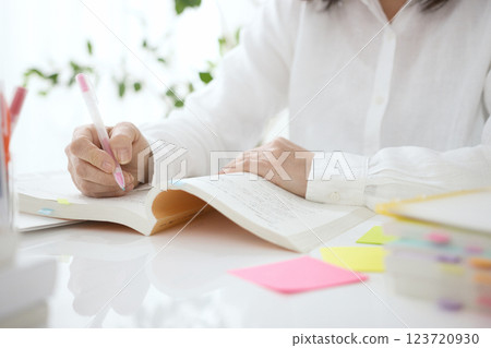 The hands of a middle-aged woman studying 123720930