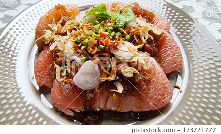 Pomelo with sweet fish sauce. Thai food. Refreshing Citrus Salad with Garnishes and Herbs on Plate 123721777