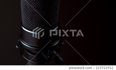 A close-up of a microphone in a dark setting. Concept is sound recording technology. 123722552