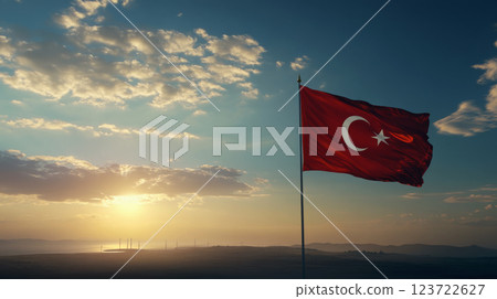 A red flag with a crescent and star waves against a backdrop of a sunset sky. Concept of national pride and serene landscape. 123722627