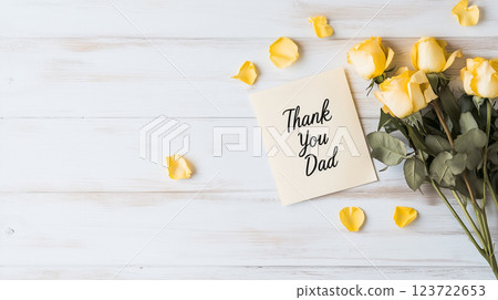Yellow roses and a thank you message on a pale wooden table | Simple beauty 123722653