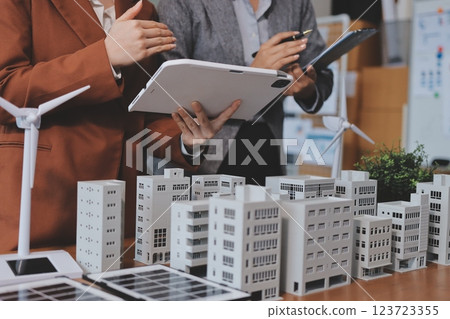 Discussion among businesspeople on the latest developments in solar cell panel technology and Solar Energy Environment city Concept. Discussion among businesspeople on the latest developments in solar cell panel technology and Solar Energy Environment city Concept. 123723355