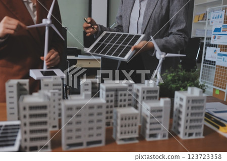 Discussion among businesspeople on the latest developments in solar cell panel technology and Solar Energy Environment city Concept. 123723358