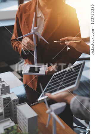 Discussion among businesspeople on the latest developments in solar cell panel technology and Solar Energy Environment city Concept. 123723359