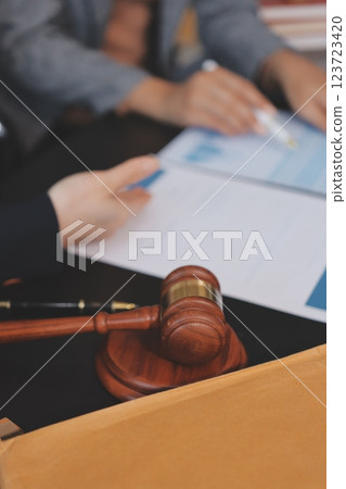 Judge gavel with Justice lawyers having team meeting at law firm background. Concepts of Law and Legal services. 123723420