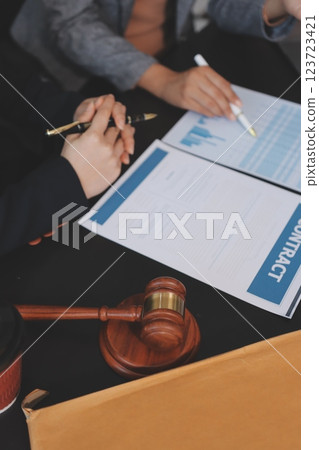 Judge gavel with Justice lawyers having team meeting at law firm background. Concepts of Law and Legal services. 123723421