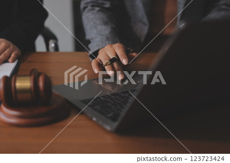 Judge gavel with Justice lawyers having team meeting at law firm background. Concepts of Law and Legal services. 123723424