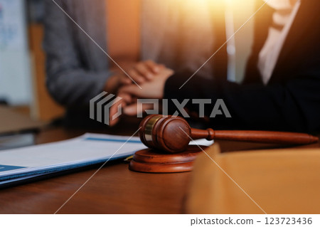 Judge gavel with Justice lawyers having team meeting at law firm background. Concepts of Law and Legal services. Judge gavel with Justice lawyers having team meeting at law firm background. Concepts of Law and Legal services. 123723436