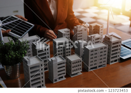 Discussion among businesspeople on the latest developments in solar cell panel technology and Solar Energy Environment city Concept. Discussion among businesspeople on the latest developments in solar cell panel technology and Solar Energy Environment city Concept. 123723453