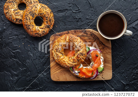 Lox bagel. A sandwich with smoked salmon, cucumbers and onions 123727072