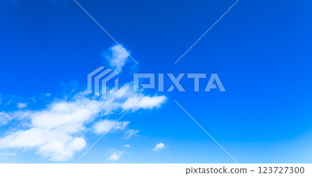 A simple landscape of clear blue sky and white clouds 123727300
