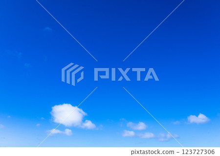 A simple landscape of clear blue sky and white clouds 123727306