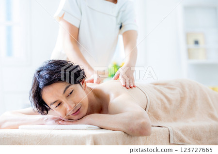 A young man receiving a massage at a beauty salon 123727665