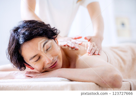 A young man receiving a massage at a beauty salon 123727666