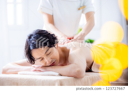 A young man receiving a massage at a beauty salon A young man receiving a massage at a beauty salon 123727667