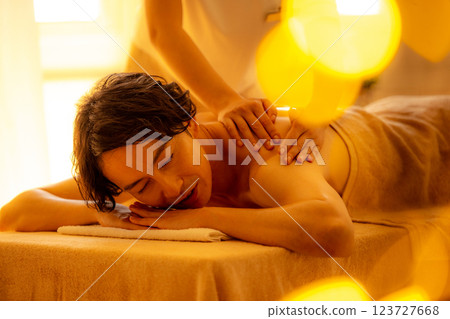 A young man receiving a massage at a beauty salon A young man receiving a massage at a beauty salon 123727668