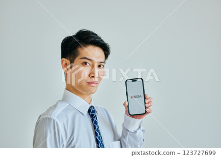 A young man in his 20s holding a smartphone New NISA A young man in his 20s holding a smartphone New NISA 123727699