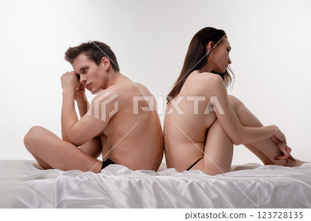 Couple in lingerie expresses emotions in intimate indoor setting 123728135