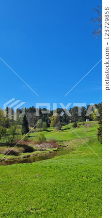 Beautiful vertical landscape with small river Beautiful vertical landscape with small river 123729858