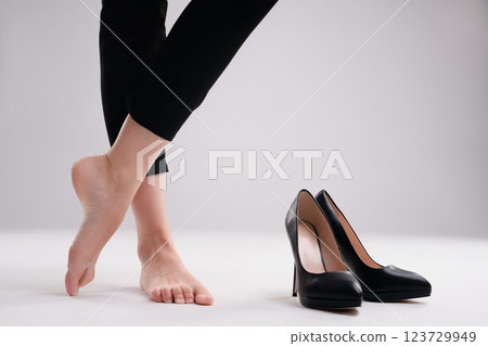 Elegant woman showcasing beauty in lingerie with high heels in studio setting Elegant woman showcasing beauty in lingerie with high heels in studio setting 123729949