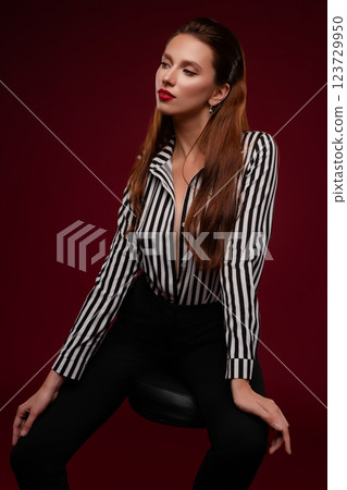 Beauty session of a woman in lingerie striking a pose in a studio setting Beauty session of a woman in lingerie striking a pose in a studio setting 123729950