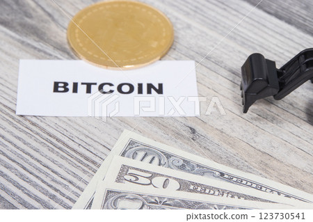 Bitcoin, miniature excavator and dollar bills 123730541