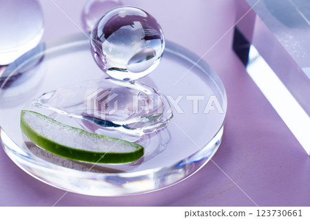 Aloe slices and serum droplets arranged on a round glass in a serene spa setting. Aloe slices and serum droplets arranged on a round glass in a serene spa setting. 123730661