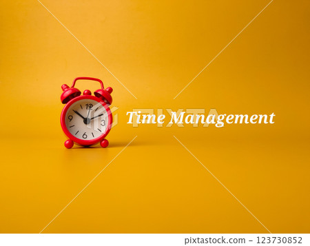 Red alarm clock with the word Time Management on a yellow background. 123730852