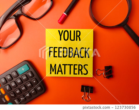 Top view sticky note written with word YOUR FEEDBACK MATTERS on a orange background. Top view sticky note written with word YOUR FEEDBACK MATTERS on a orange background. 123730856