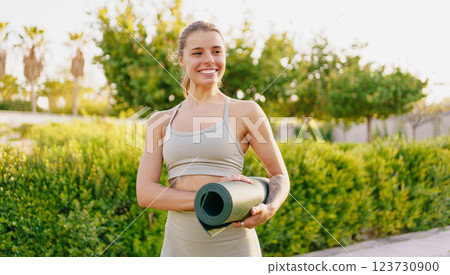 A passionate yoga enthusiast deeply enjoying the serene beauty of nature on their yoga mat 123730900